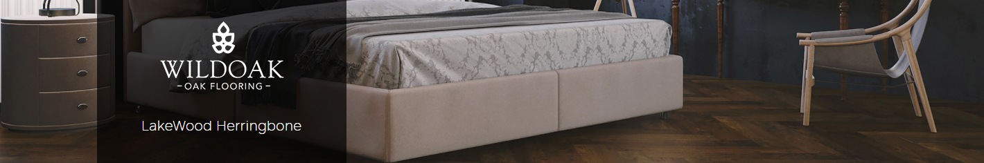 LakeWood Herringbone flooring in a stylish bedroom setting, featuring a bed with decorative bedding, a nightstand, and a modern chair against a dark wall backdrop.