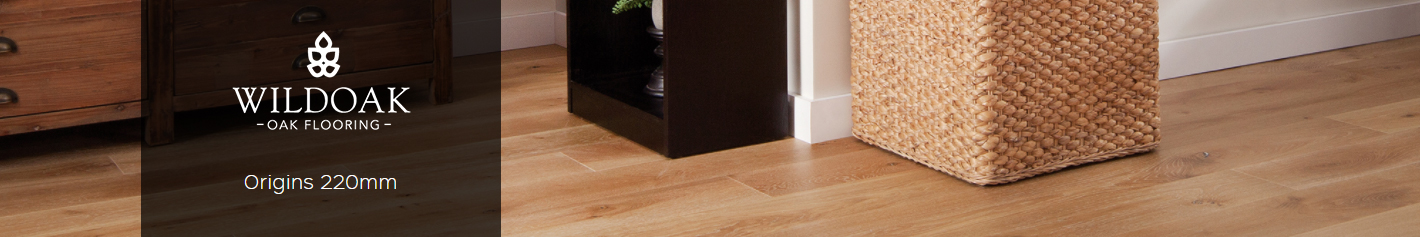 Origins 220mm engineered timber flooring by Wildoak, featuring warm wood tones, a woven storage basket, and modern decor elements.