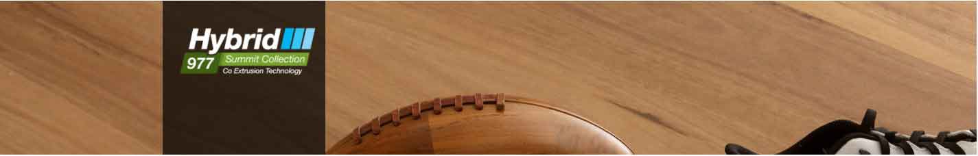 Hybrid flooring sample from the Resiplank range, showcasing wood texture, logo for Hybrid 977 Summit Collection, and athletic footwear, emphasizing durable and stylish flooring options.