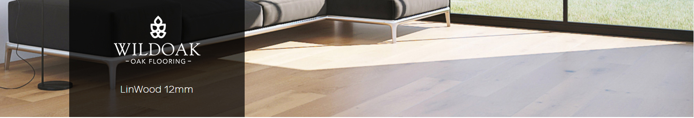 Misty Grey 12mm LinWood engineered timber flooring showcased in a modern interior setting with a sleek black sofa and large windows.