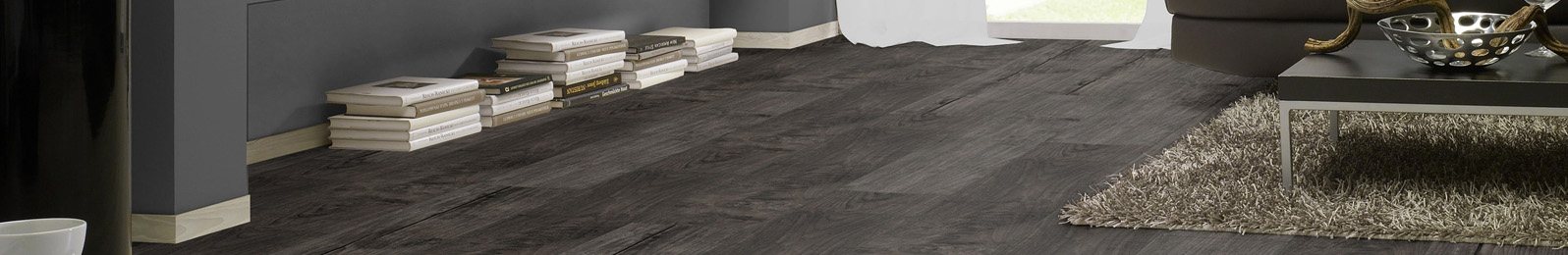 Swish Laminate Aqua flooring in a stylish interior setting, showcasing dark wood texture, suitable for moisture-laden areas like kitchens and bathrooms, emphasizing safety and low maintenance.